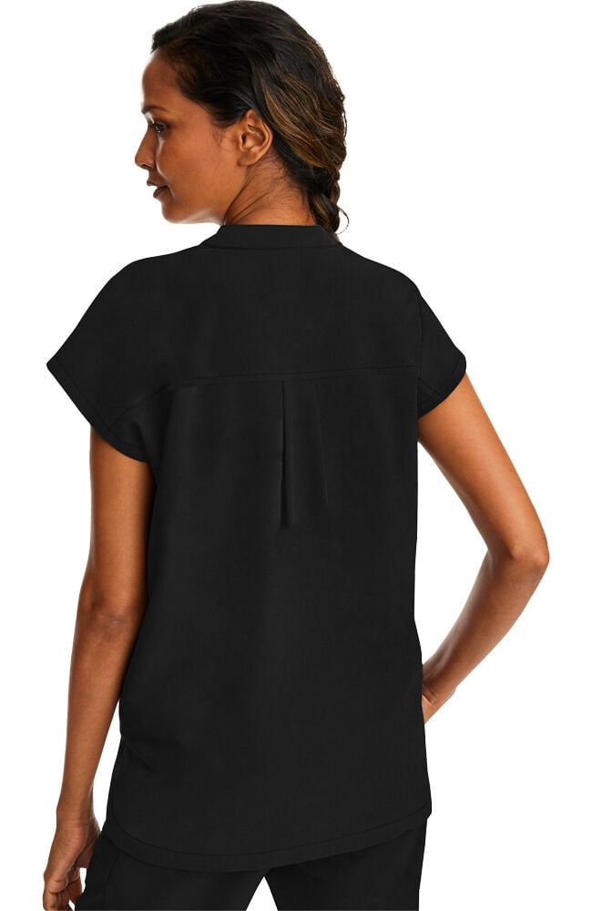 Woman in black shirt, turned to side. Shirt has short sleeves and a vertical back seam.
