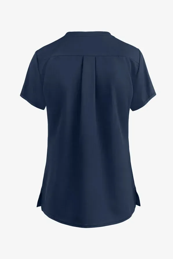 Navy blue short-sleeved scrub top, viewed from the back, with vertical pleats and side slits.