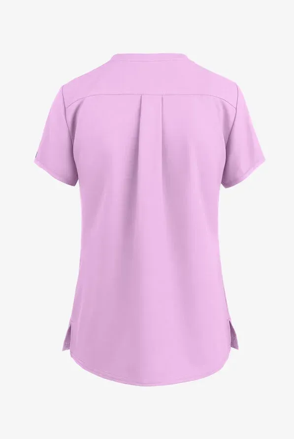 Back of a light purple short-sleeved medical scrub top with a center pleat and side slits.