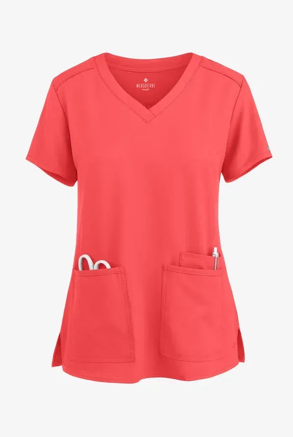 Coral-colored V-neck medical scrub top with two front pockets. Scissors and a pen are in the pockets.