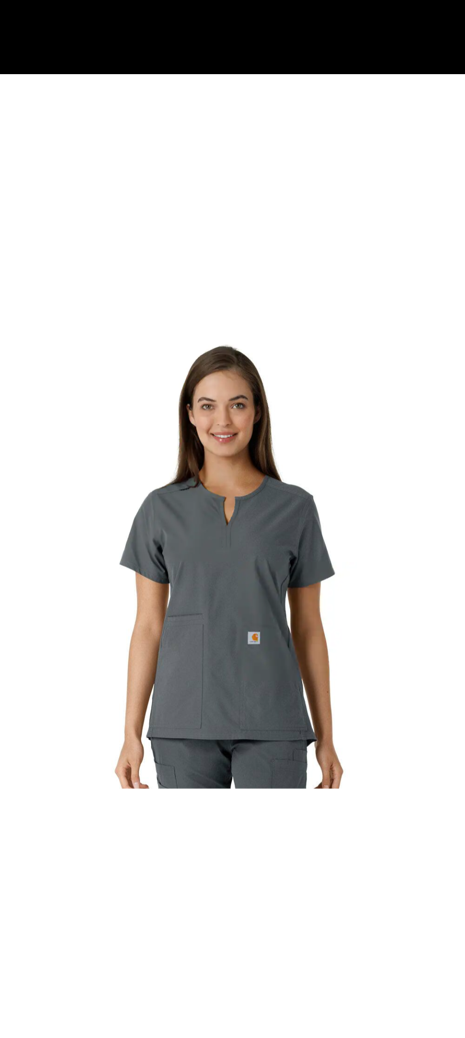 Woman in gray medical scrubs, standing and smiling, on white background.