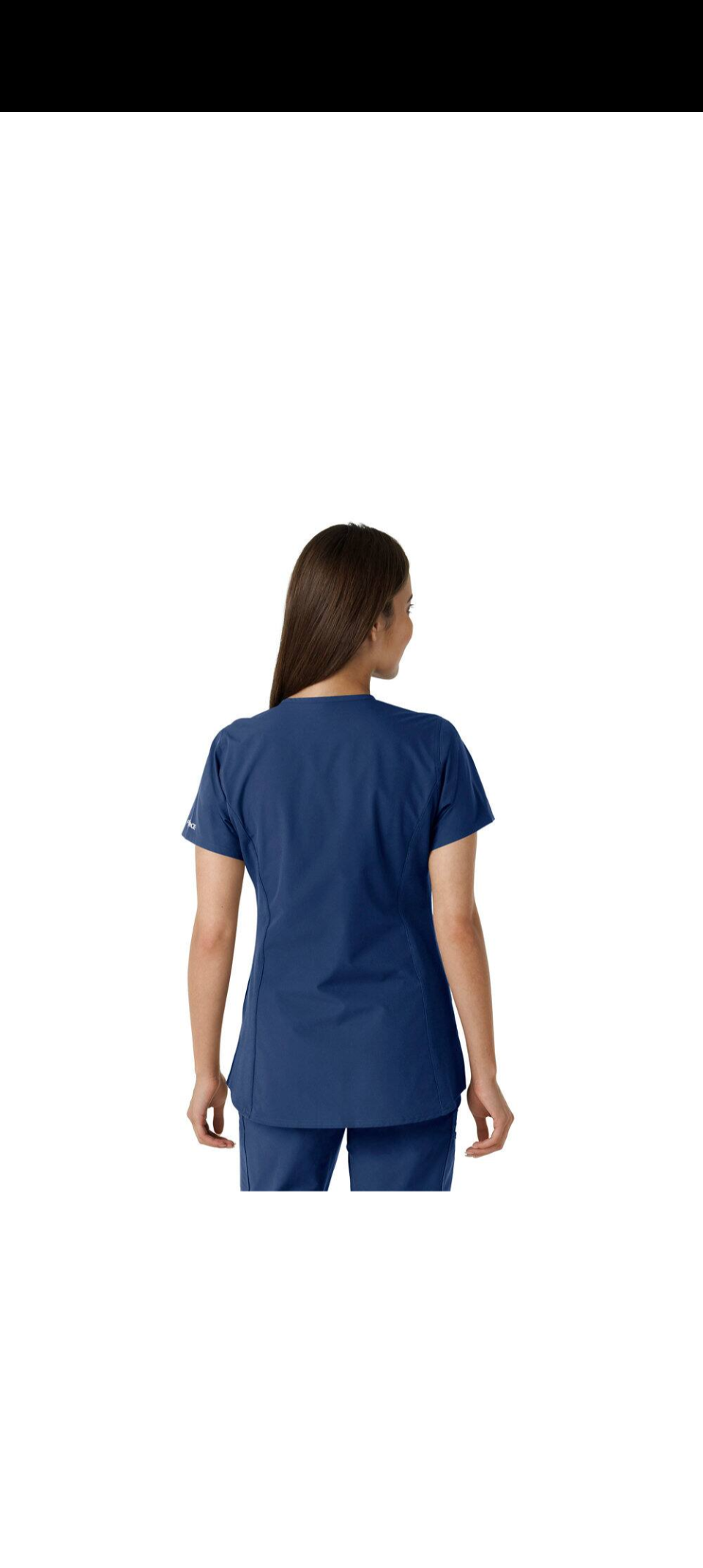 Woman wearing a navy blue scrub top and pants, back view.
