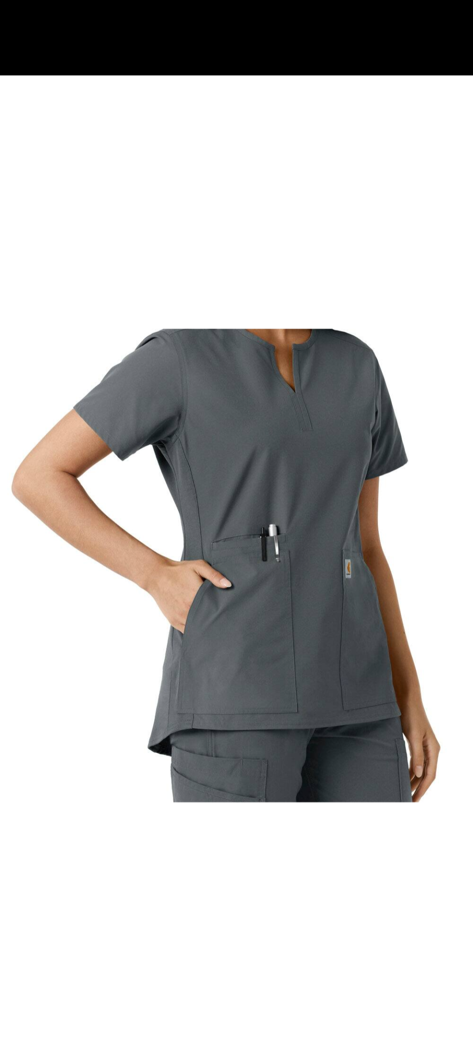 Woman wearing a gray medical scrub top with short sleeves and pockets.