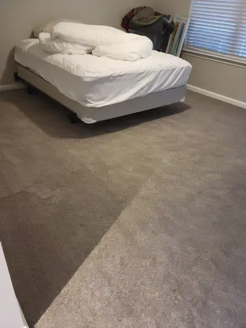 A bedroom with a bed and a window.