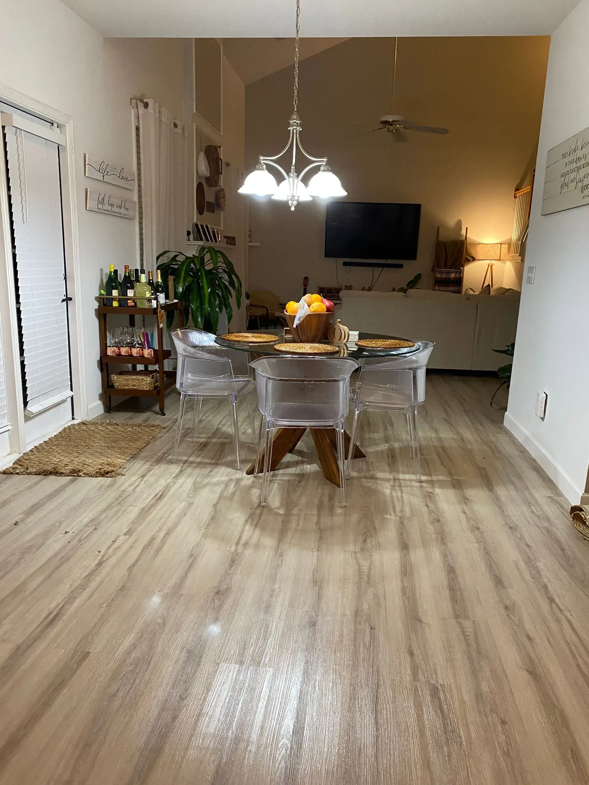 A dining room with a table and chairs and a chandelier.