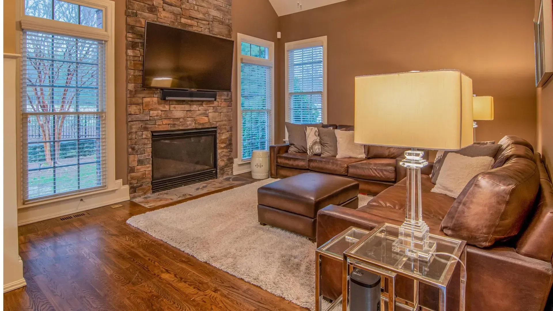 A living room with a couch , fireplace and television.