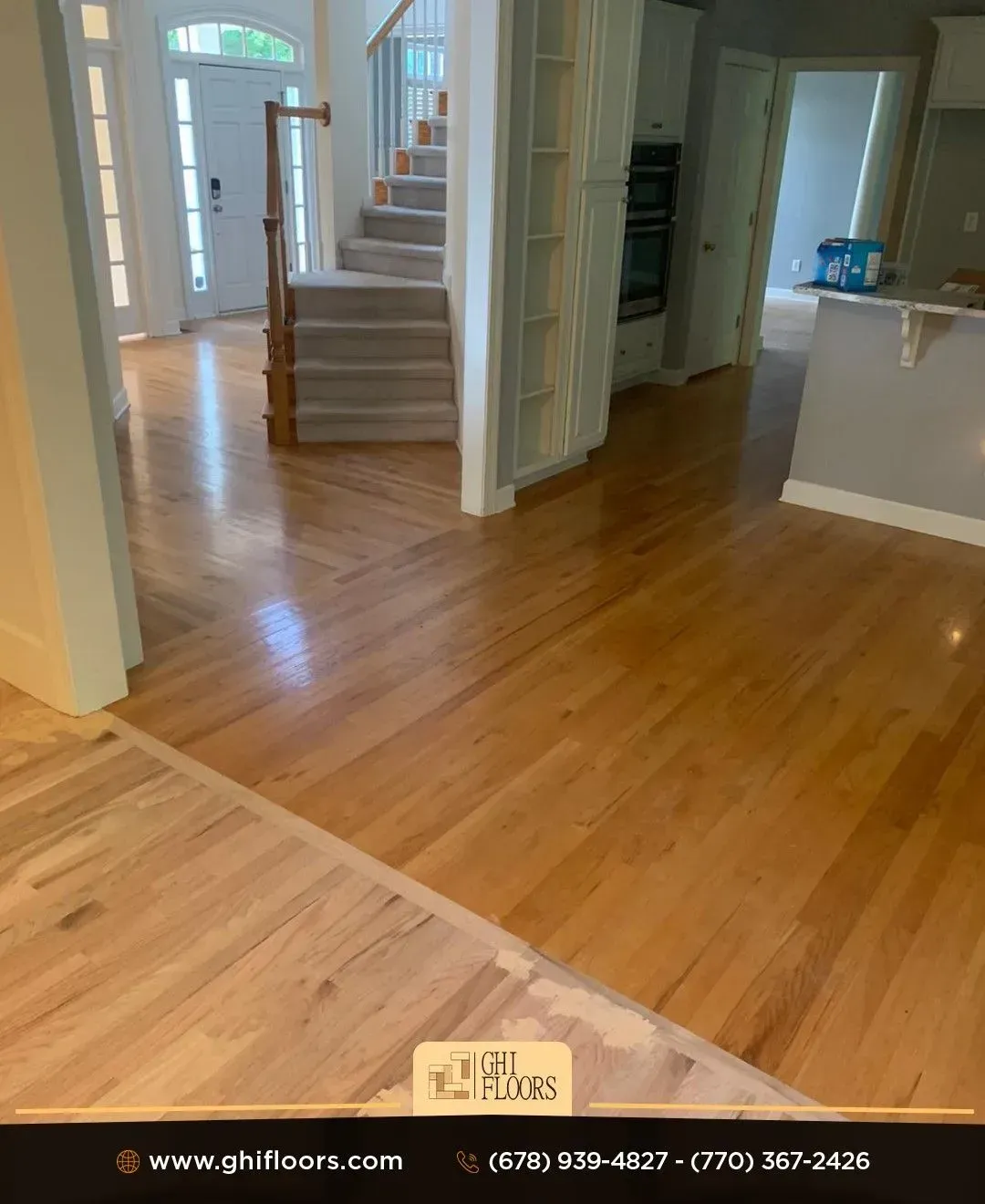 A living room with hardwood floors and stairs