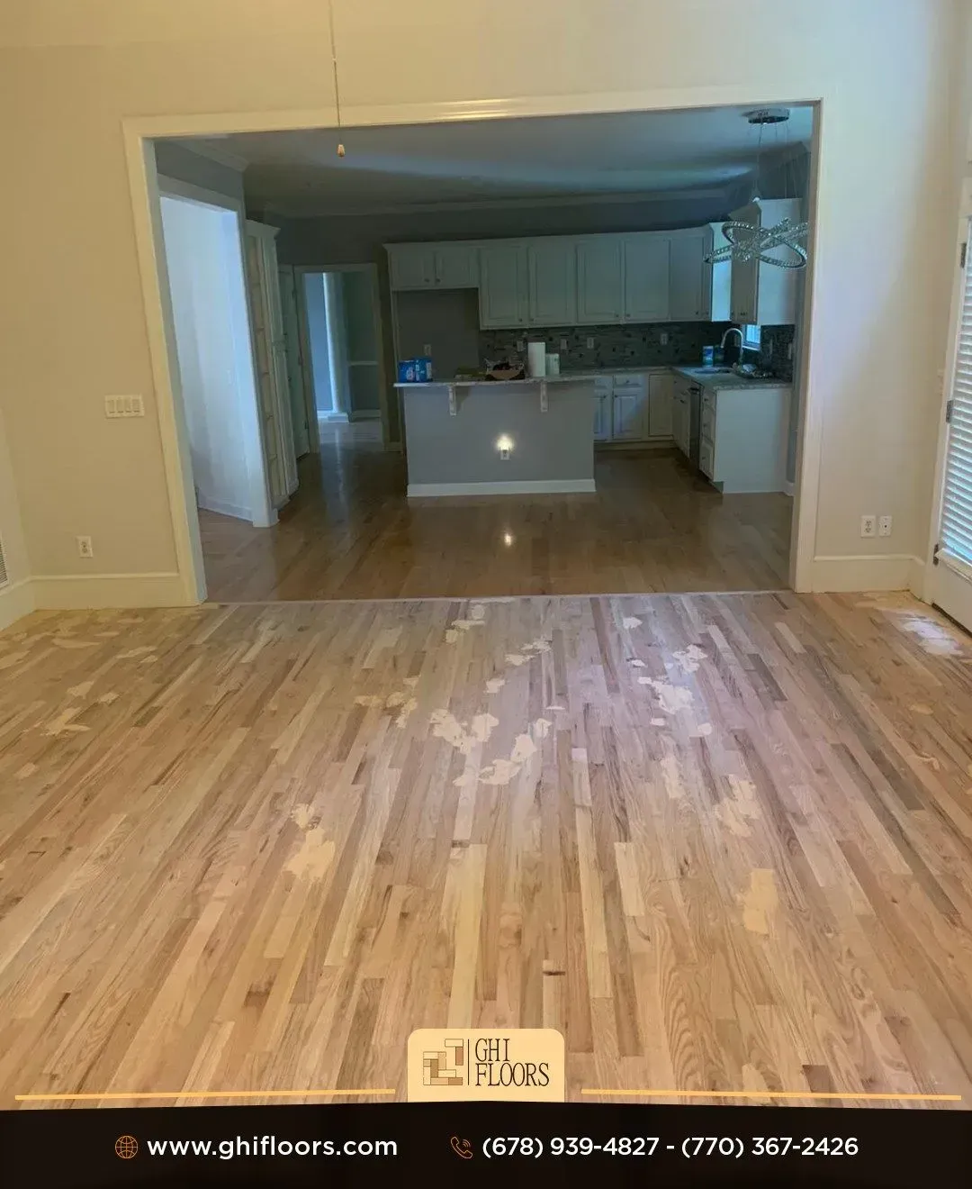 A kitchen with a wooden floor and white cabinets.