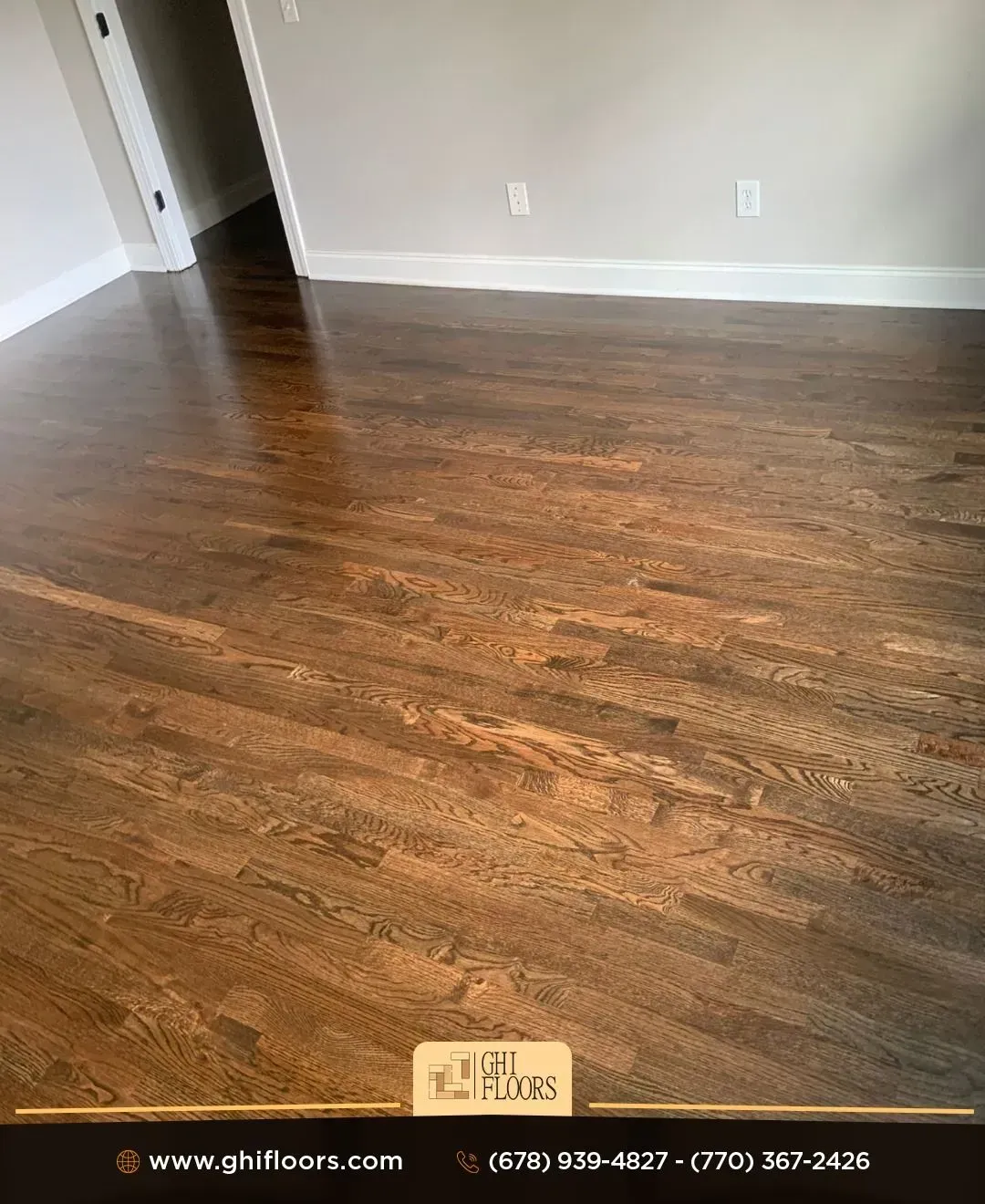 A living room with a wooden floor and white trim.