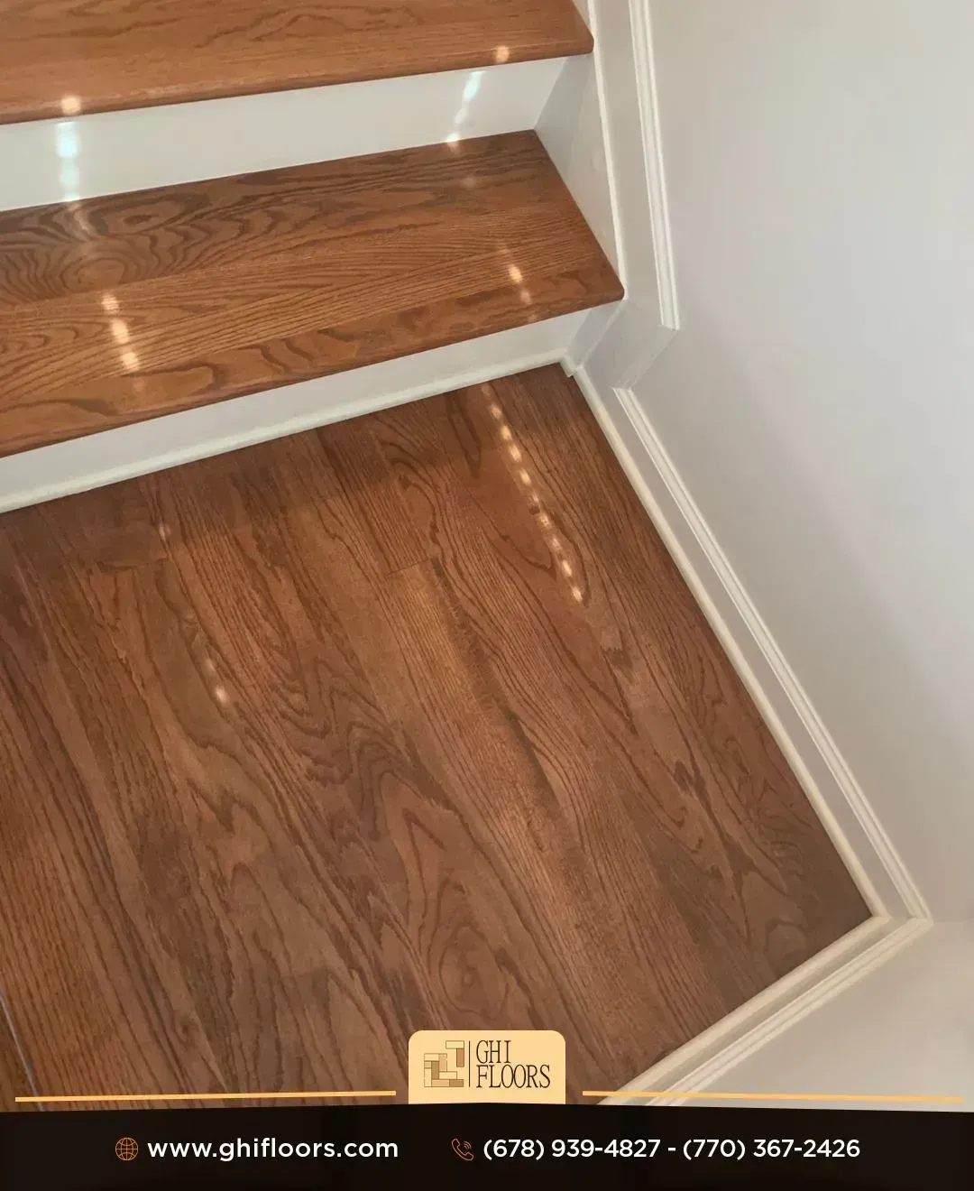A close up of a wooden floor next to a set of stairs.