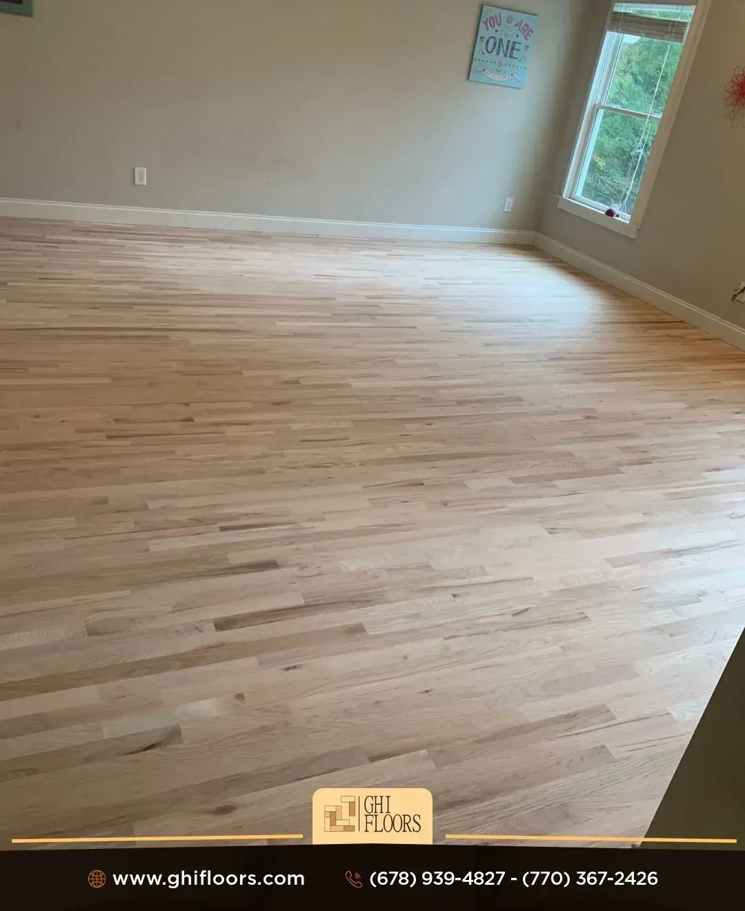 A living room with hardwood floors and a window.