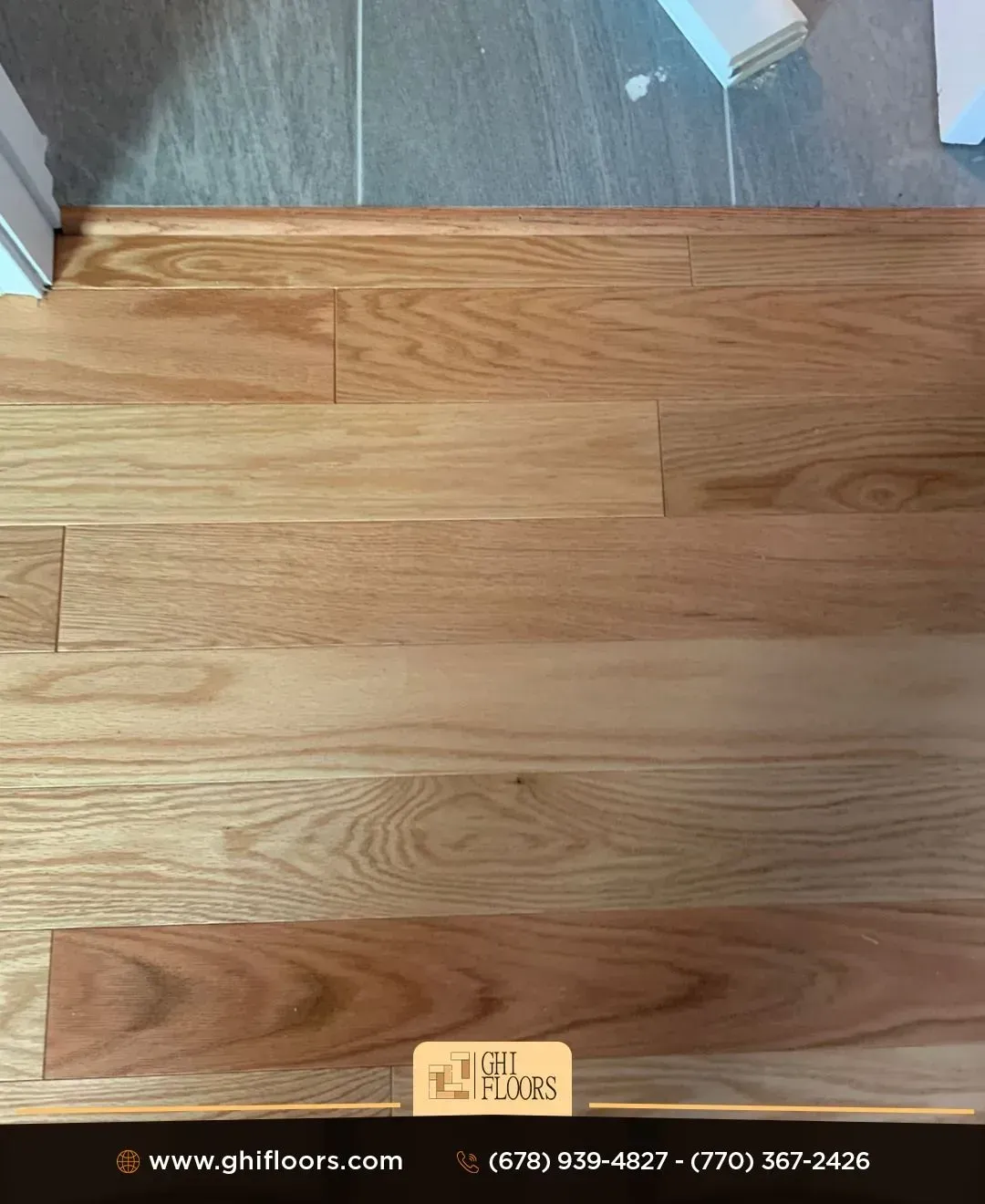 A kitchen with a wooden floor and white cabinets.