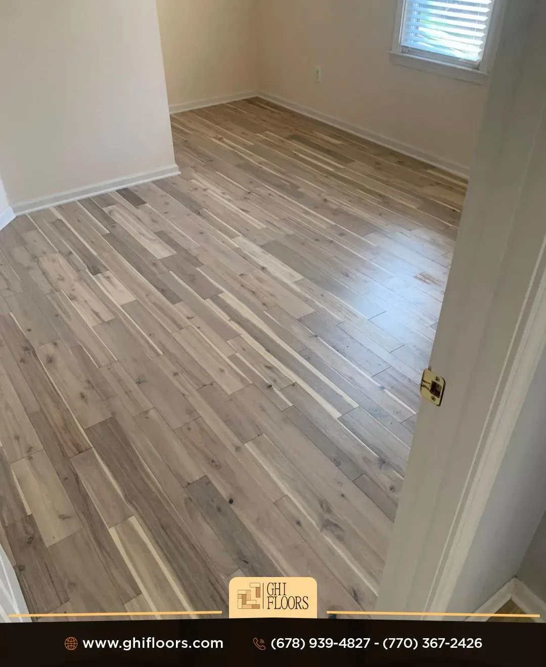 A bedroom with hardwood floors and a window.
