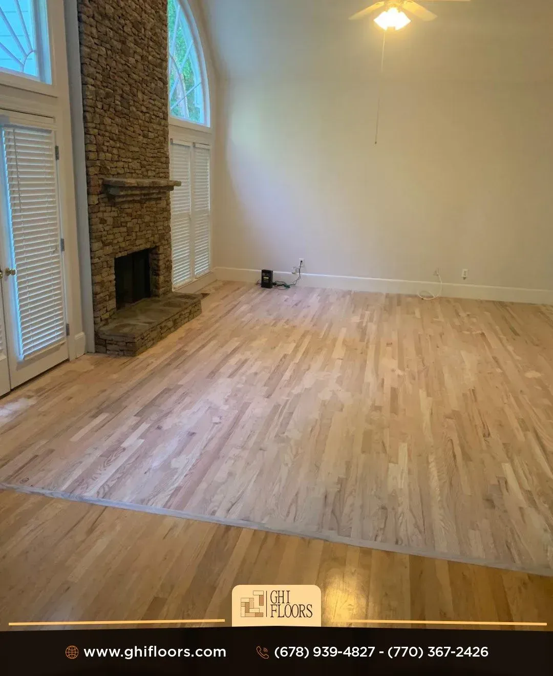 A living room with hardwood floors and a fireplace.