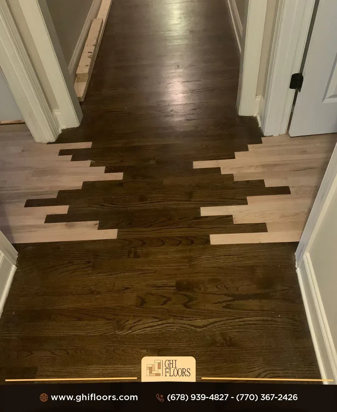 A hallway with a wooden floor and a white wall.