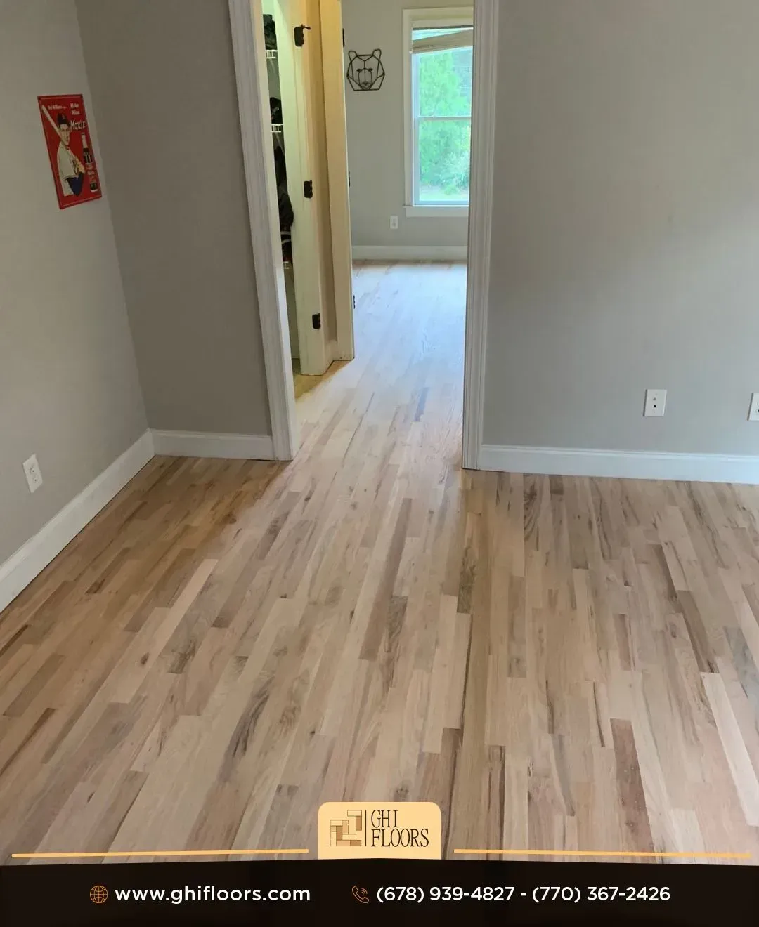 A room with a wooden floor and a doorway leading to another room