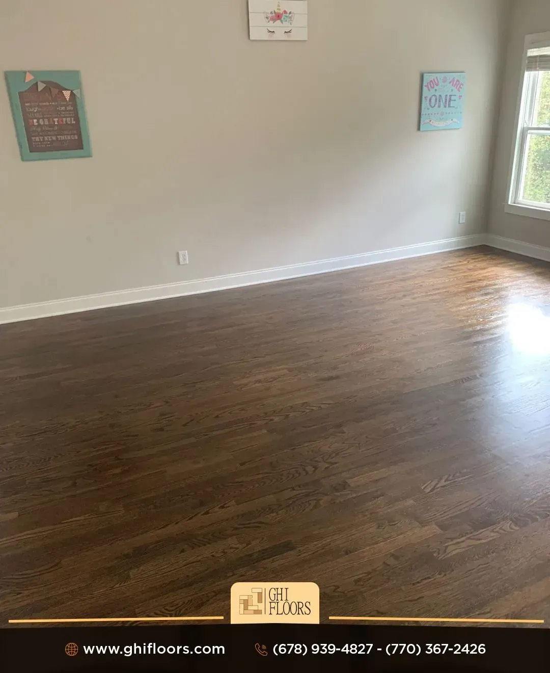 An empty room with hardwood floors and a window.