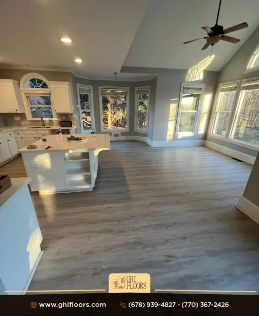 A kitchen with a large island and a ceiling fan.