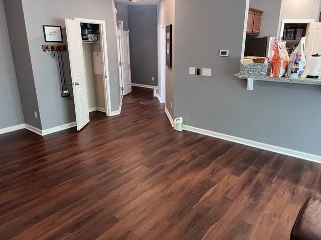 A living room with hardwood floors and gray walls.
