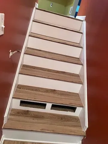 A set of stairs with wooden steps in a house.