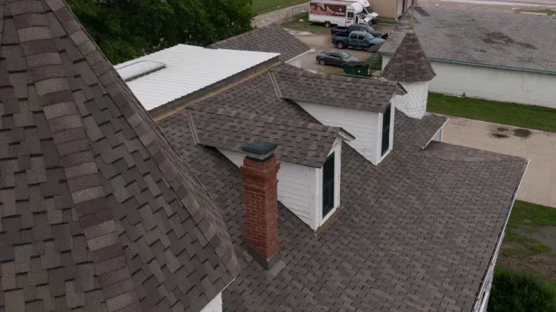 An aerial view of a house with a chimney on the roof.