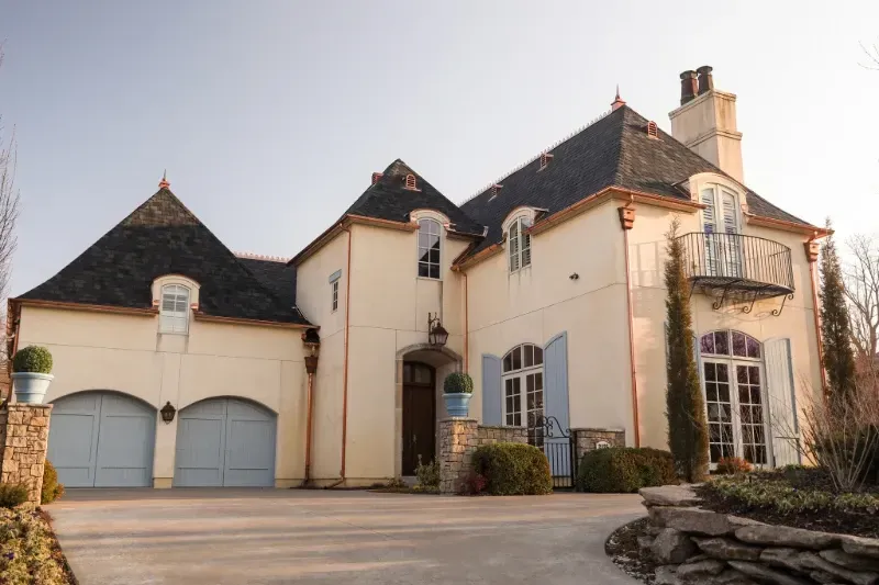 A large house with two garages and a balcony