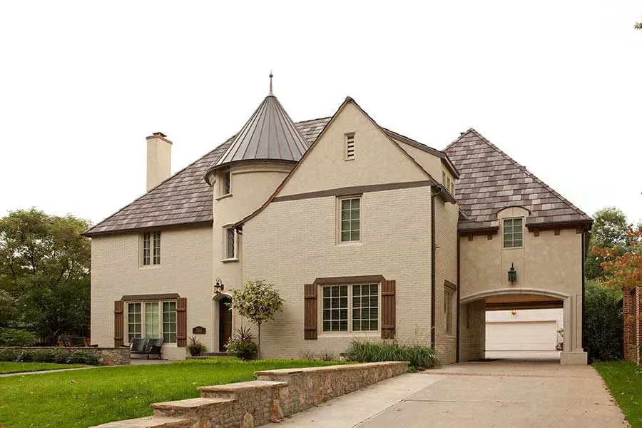 A large house with a gray roof and a white garage door