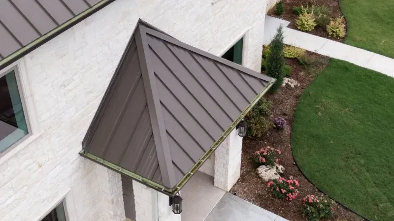 An aerial view of a house with a canopy over the door.