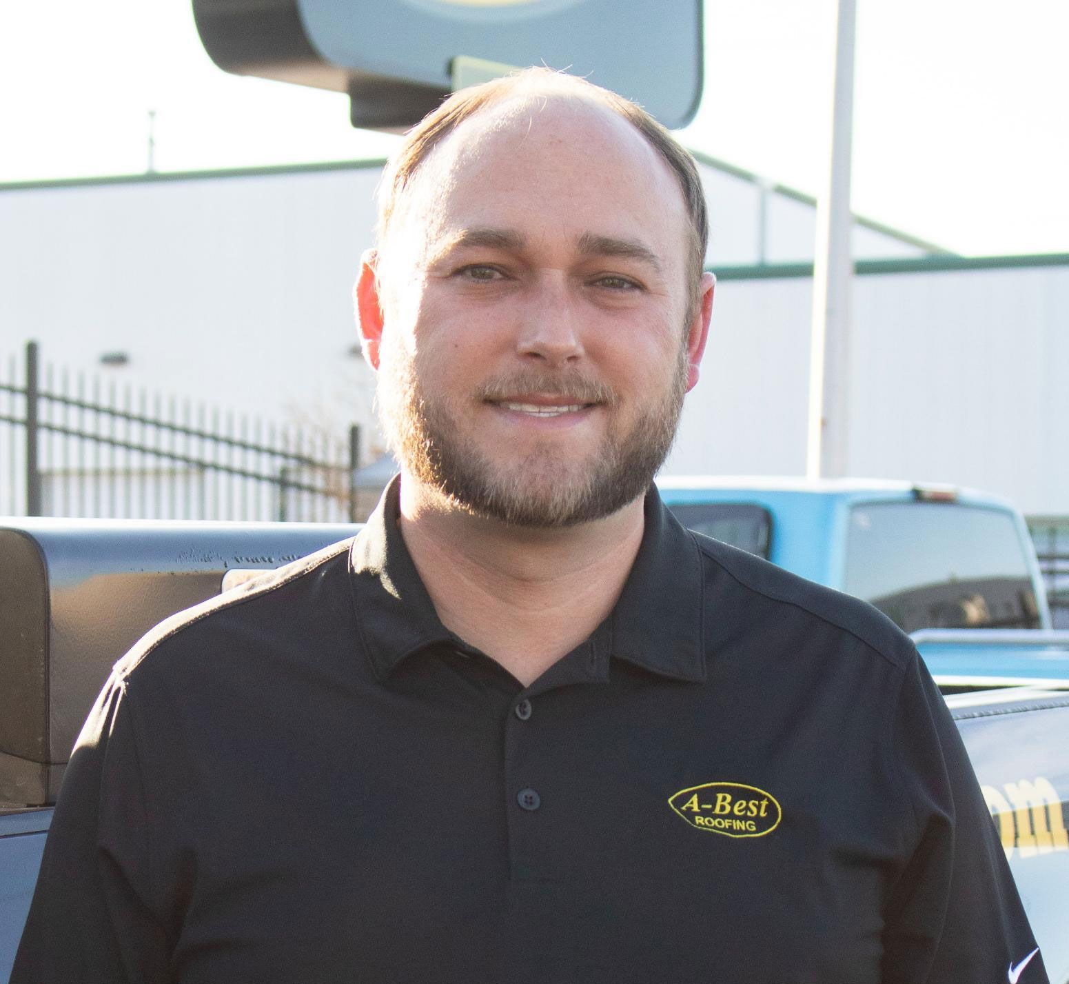 A man wearing a black shirt with the word allen on it