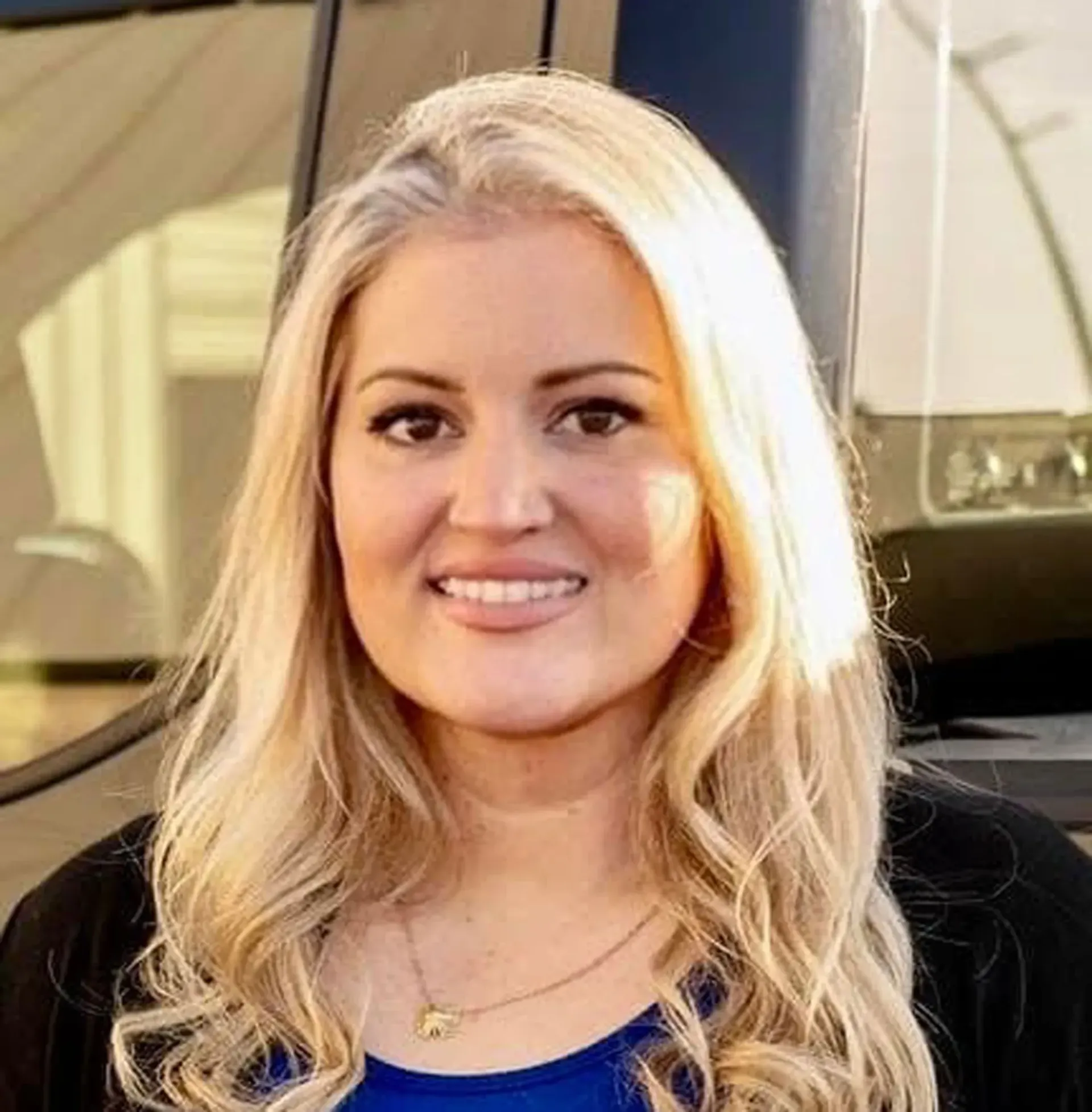 A woman is sitting at a desk in front of a computer.