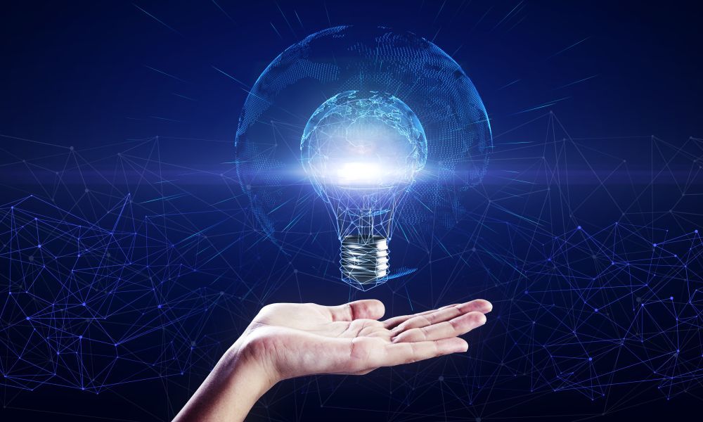 A person is holding a light bulb in their hand.