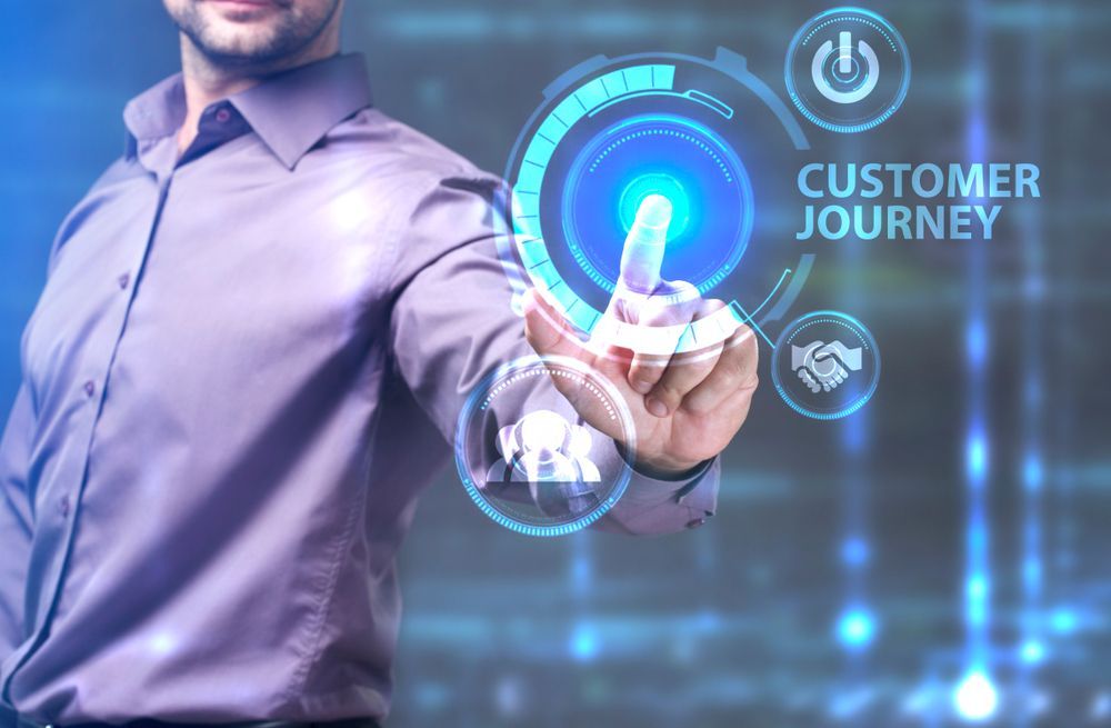 A man is pressing a button on a screen that says customer journey.