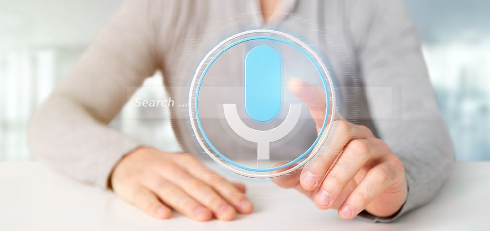 A woman is holding a voice search system
