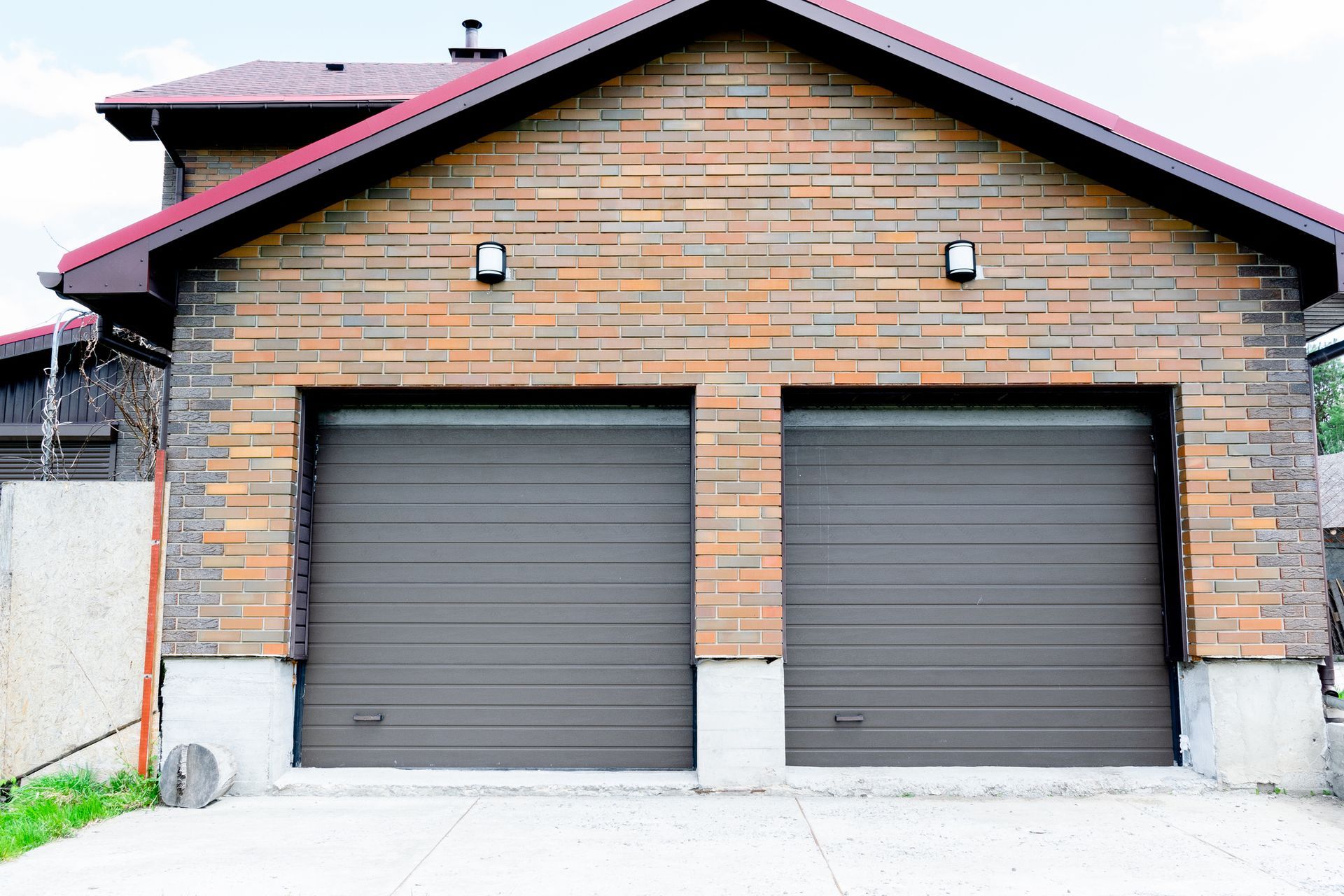 New modern parking garage in residential luxury brick house with roller shutters on gates.