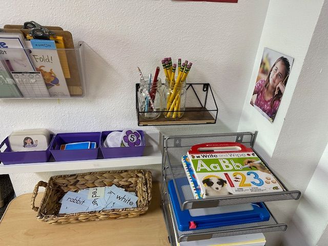 Playroom with tables, a foosball table, a world map, and colorful decorations.