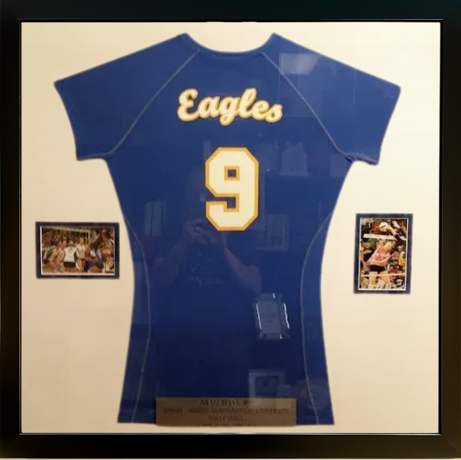 Framed blue Eagles jersey with number 9, two small photos, and a plaque.