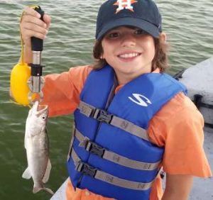 young boy holding fish