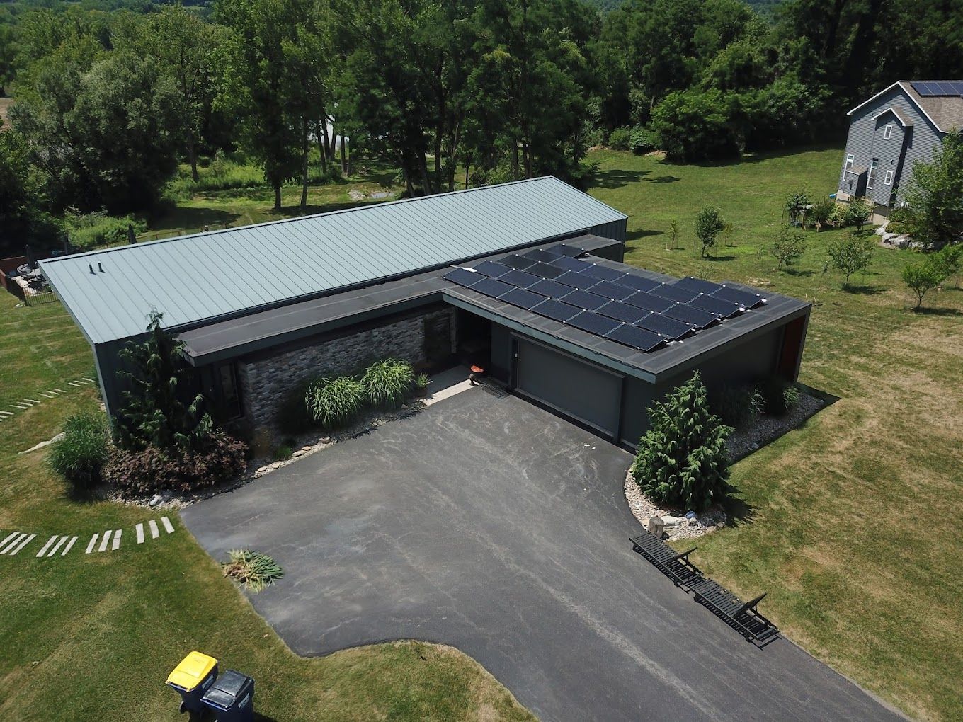 an aerial view of a house with solar panels on the roof