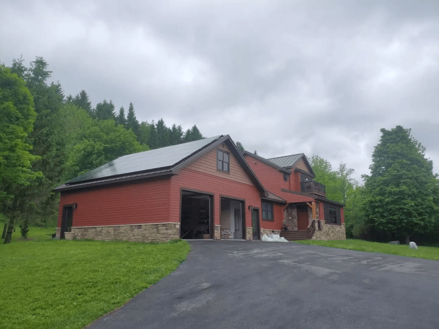 a large red brick house with a garage and a driveway