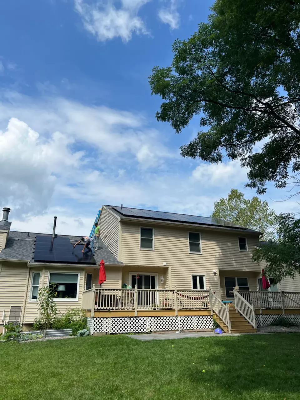 a house with a deck and solar panels on the roof