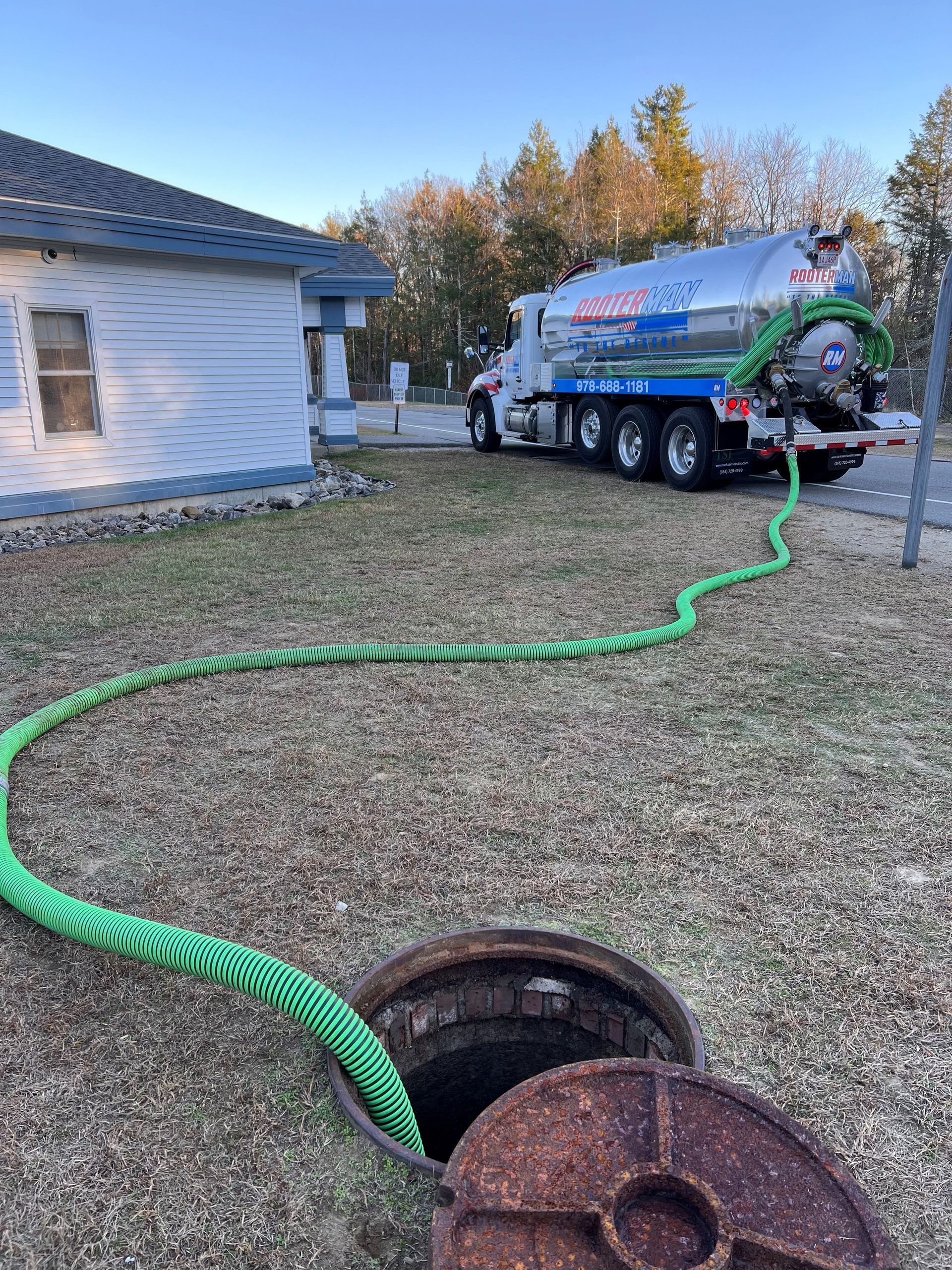 Water gushing from a leaky sink pipe into a bucket below.