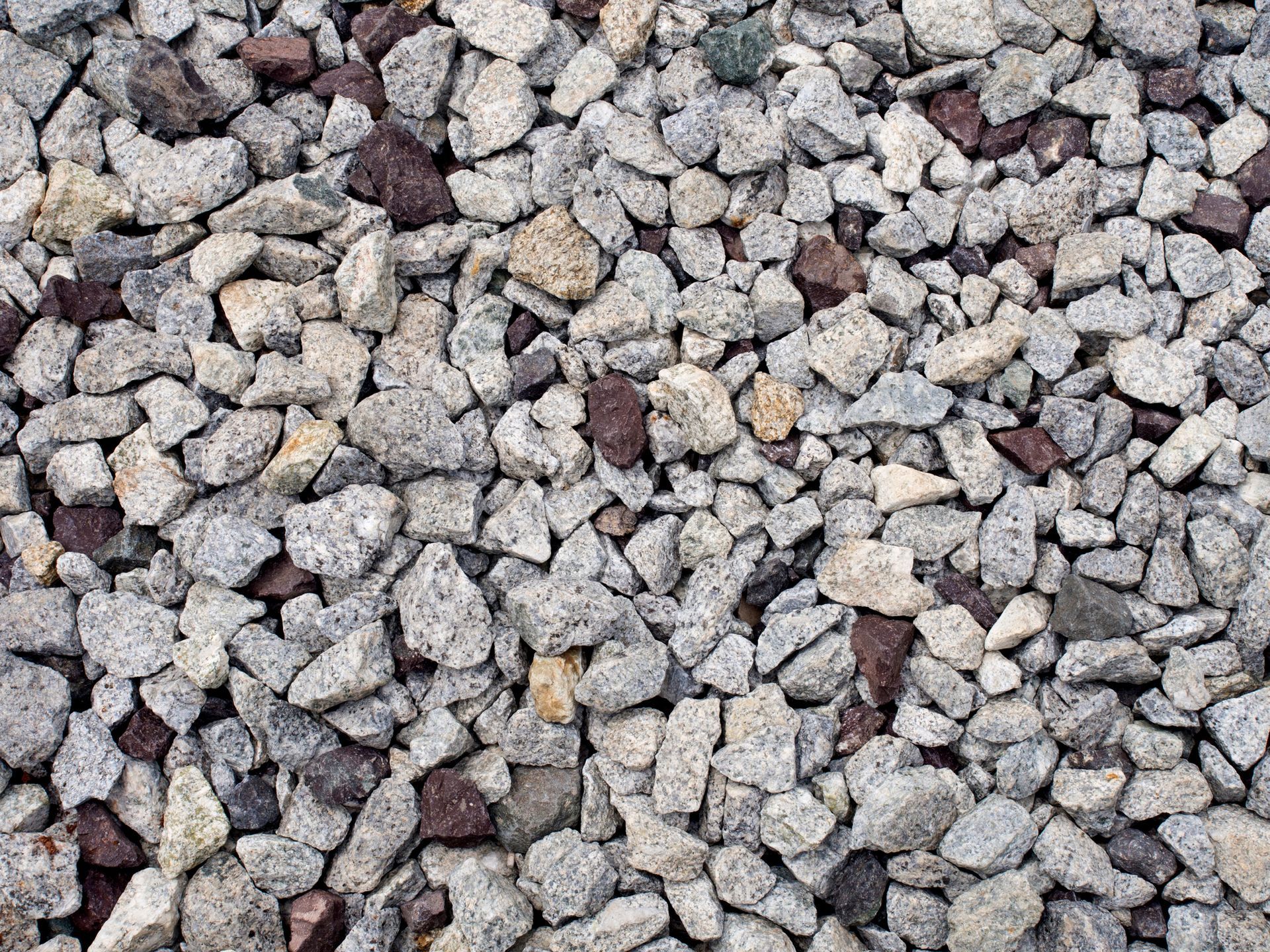 A pile of blue granite is sitting on the ground.
