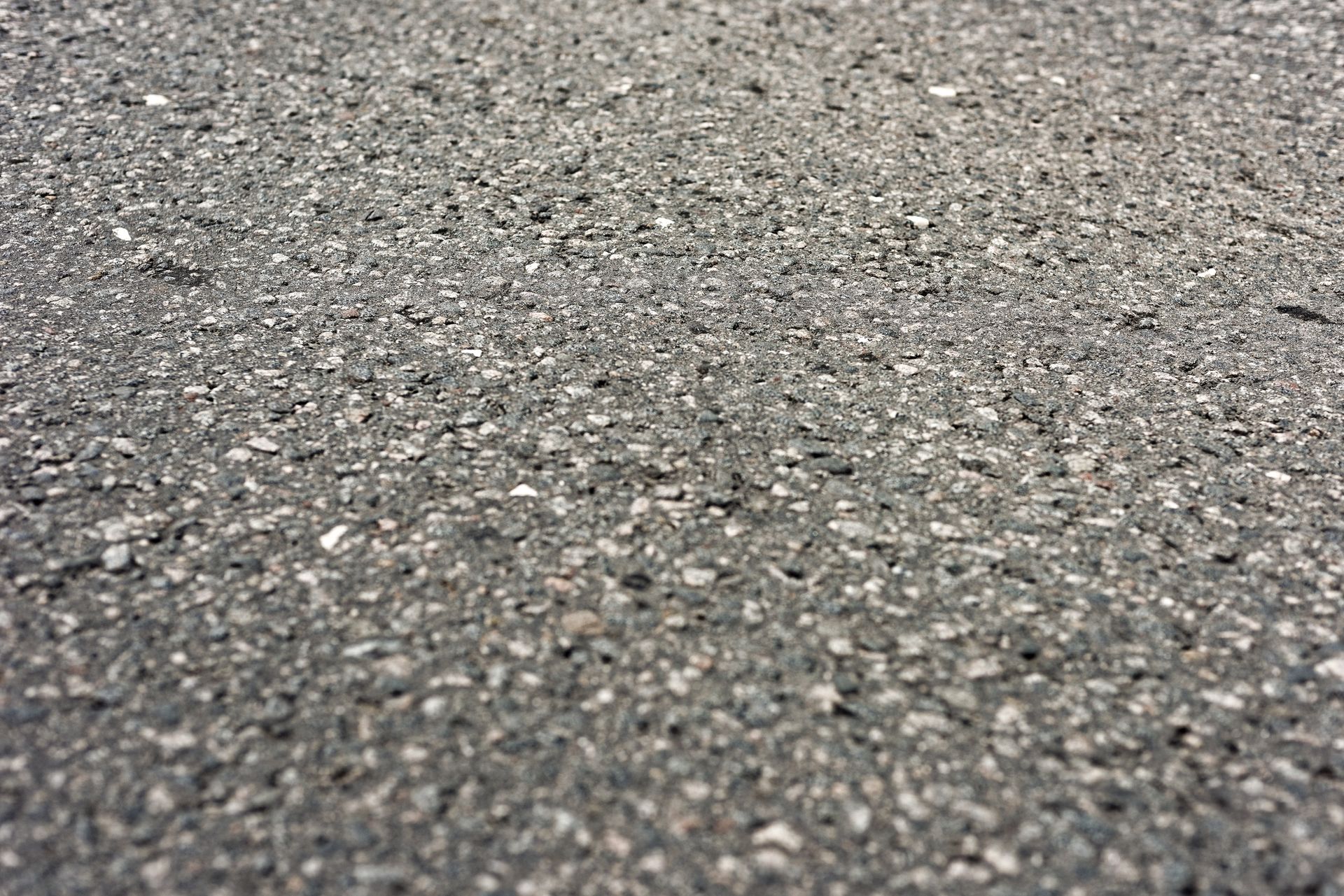A close up of a gray carpet with a lot of small stones on it.