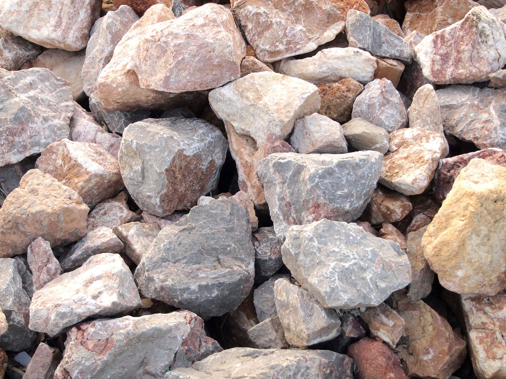A pile of rocks is sitting on the ground.
