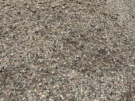 A pile of gravel is sitting on the ground.