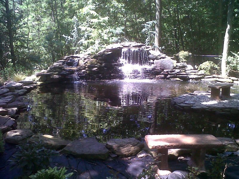 A Pond With A Waterfall In The Middle Of It — Columbus, NJ — G & G Landscaping Construction, Inc.