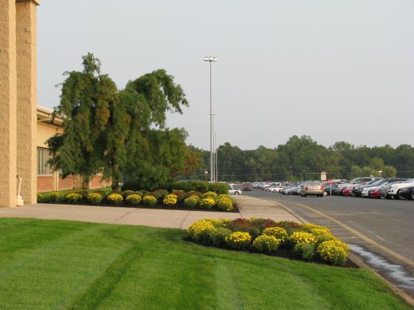 A Parking Lot With Cars Parked In Front Of A Building — Columbus, NJ — G & G Landscaping Construction, Inc.
