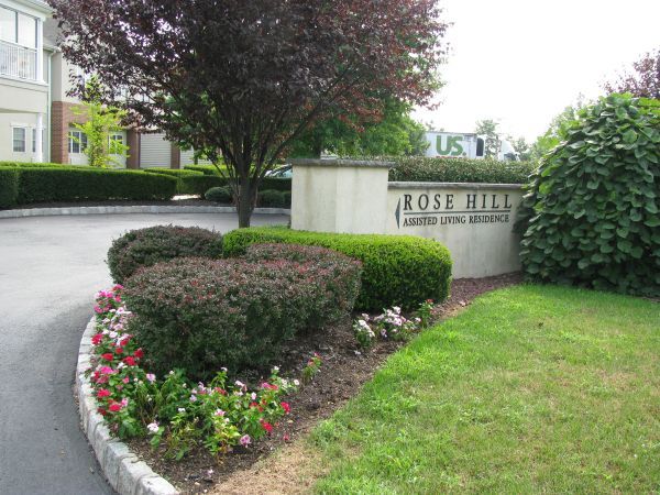 A Sign For Rose Hill Is Surrounded By Bushes And Flowers — Columbus, NJ — G & G Landscaping Construction, Inc.