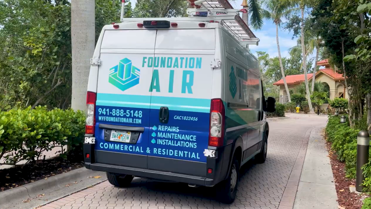 Foundation Air service van parked on a brick path in a leafy residential area