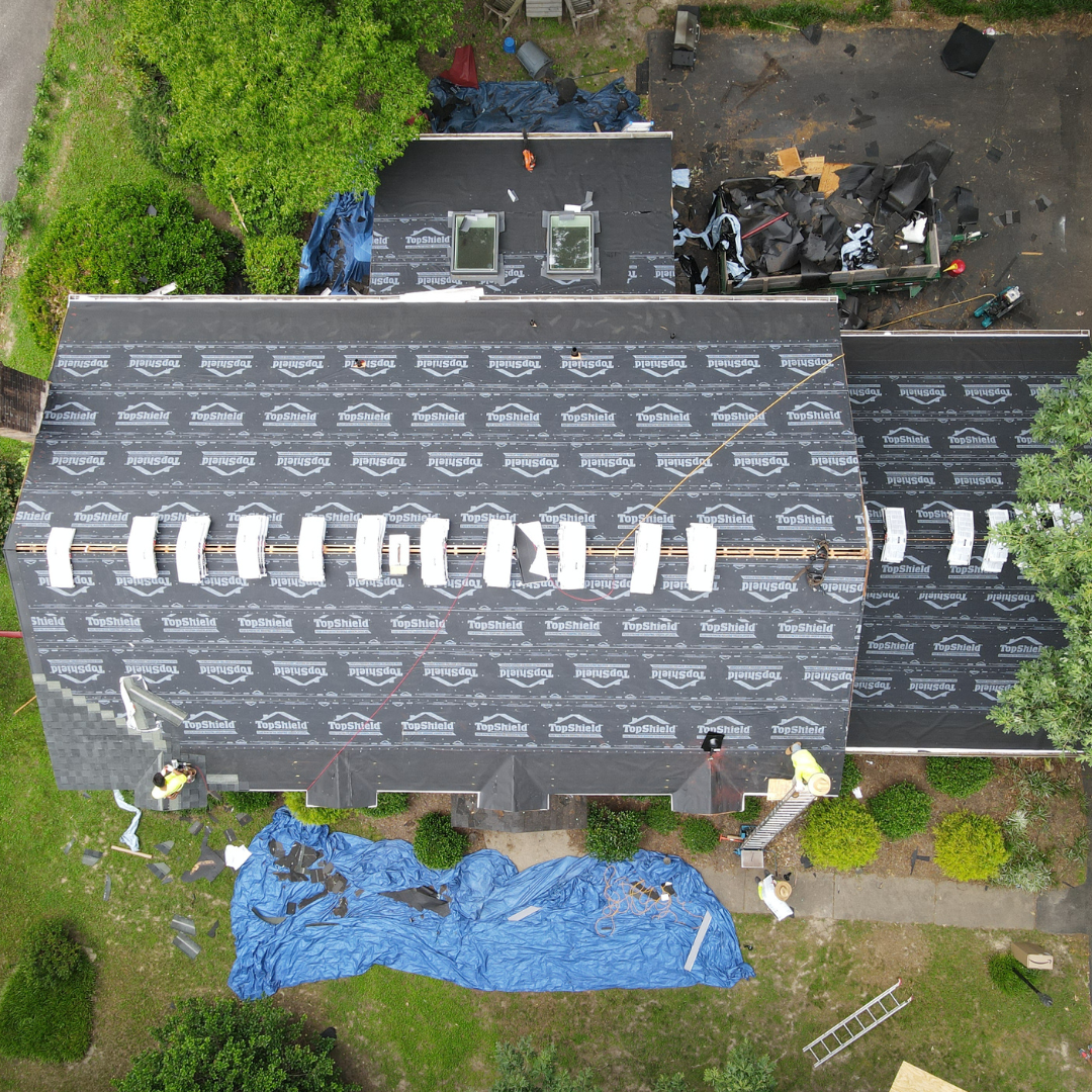 A drone image of a RETEX roof replacement in North Chesterfield VA 23235. Image shows shingle installation step.